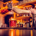Bartender pouring a cocktail at the bar
