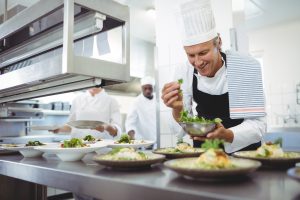 How to open a restaurant with no experience: a chef plating dishes at the pass